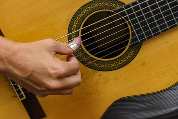 Wall Mural - Musician hands playing acoustic guitar during presentation