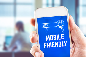 Wall Mural - hand holding mobile with mobile friendly and search icon feature