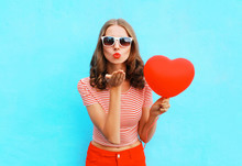 Portrait Pretty Woman Sends Air Kiss With Red Balloon Heart Shap