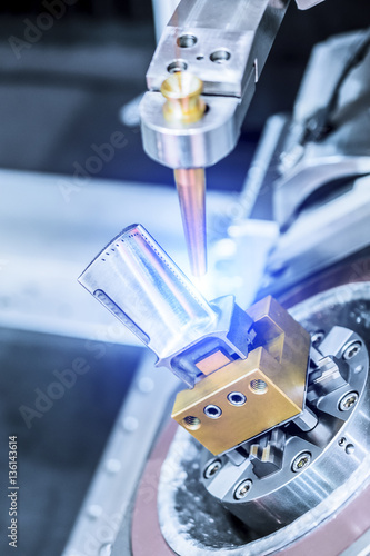 Fotografie, Obraz EDM machine handles aircraft engine turbine blade.