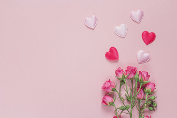 Wall Mural - Bouquet of roses and hearts on a pink background. Space for text