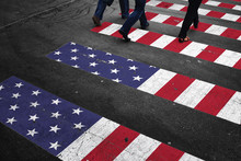 Road Crossing With Group Of People And Painted Usa Flag On The Asphalt Floor.