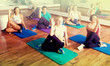 © JackF - Adults having yoga class in sport club