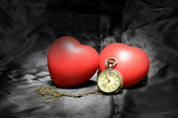 vintage clock and red heart on black background ,Love and time concept in still life photography.