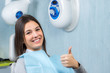 © karelnoppe - Cute girl doing thumbs up in dental clinic.