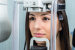 © karelnoppe - Face shot of girl in panoramic dental x-ray machine.