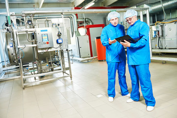 pharmaceutical male workers in water preparation production line