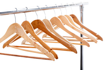 wooden empty hangers for clothes on rack on white background. no