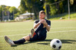 © Syda Productions - injured soccer player with ball on football field