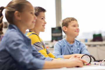 happy children building robots at robotics school