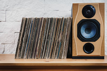 Wooden Shelf Full Of Old Vinyl Records And Speaker
