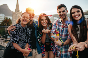 Wall Mural - Friends hanging out together on rooftop party