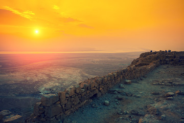 Wall Mural - Beautiful sunrise over Masada fortress. Ruins of King Herod's palace in Judaean Desert.