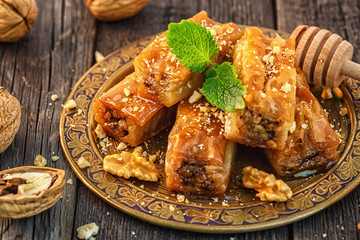 Wall Mural - Traditional arabic dessert Baklava with honey and walnuts.