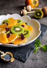 Poster - Fruit salad with Minneola tangelo, kiwi, persimmons, cranberries, sprinkled with poppy seeds