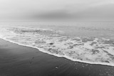 Fototapeta Na ścianę - The sea washes the beach.
Black and white photo shows a beautiful abstract atmosphere.