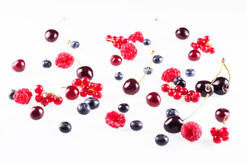 Fresh ripe raspberries, blueberries and cherries on white backgr