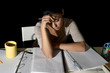 © Wordley Calvo Stock - Spanish girl studying tired and bored at home late night looking sad and stressed preparing exam