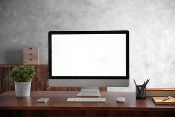 Modern computer monitor on wooden desk