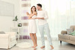 © Africa Studio - Cute young couple dancing at home