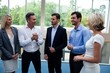 © WavebreakMediaMicro - Business executives interacting in a conference center lobby