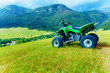 © jozefklopacka - Green Quad in landscape with village in the background.