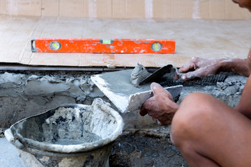 Wall Mural - Construction hand holding trowel plastering concrete