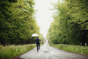 Wall Mural - Happy couple in the rain