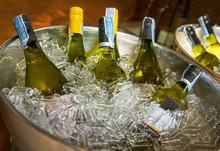 Bottles Of White Wine On Ice Bucket At A Party.