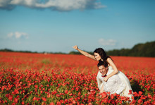 Happy Couple Having Fun In A Field Of Poppies