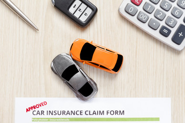 Wall Mural - Top view of approved car insurance with car key, car toy and calculator