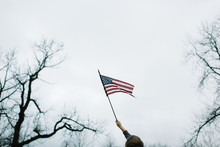 Boy Waving An American Flag Outdoors