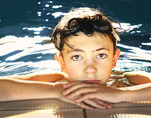 Wall Mural - boy in water galsses close up portrait in swimming pool