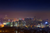 Fototapeta Miasto - Night over Almaty. 
Night view of the city of Almaty at night time. Distant buildings are covered with fog.