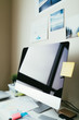 © ZeroThree - Computer desk with photos and sticky notes
