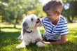 © WavebreakMediaMicro - Boy with dog in park