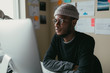 © ZeroThree - African american man reading his computer screen