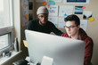 © ZeroThree - Two men working togehter in a small home office.