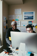 © ZeroThree - Two men working togehter in a small home office.