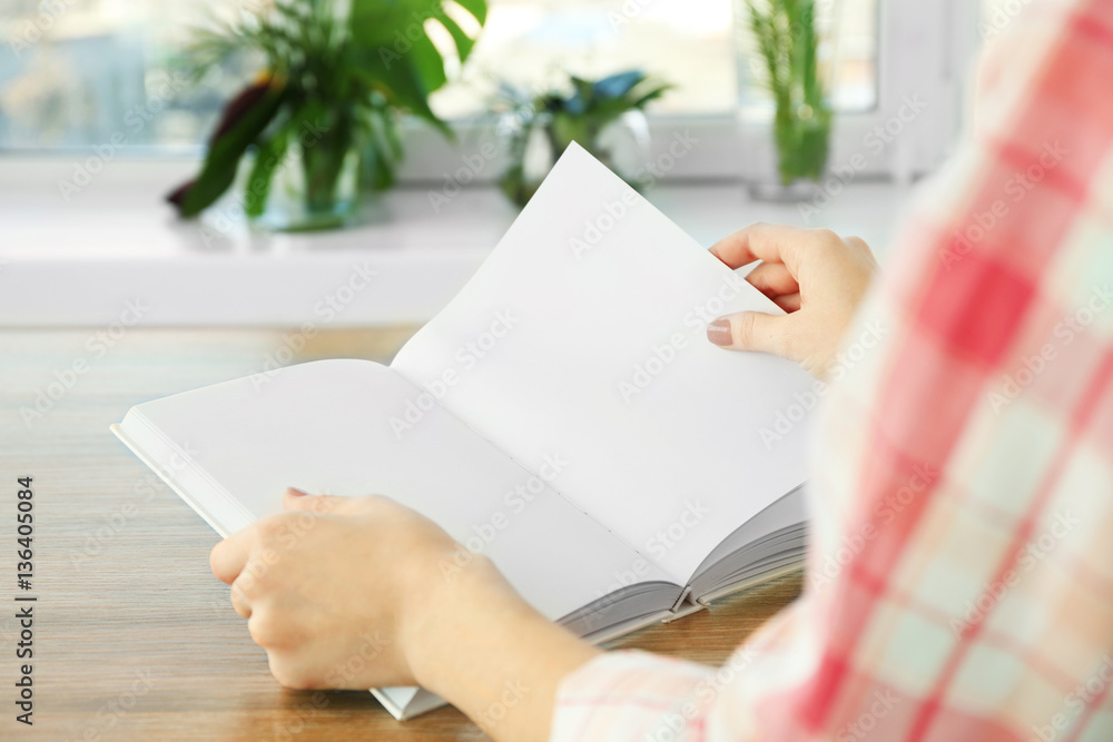 Closeup of woman holding opened book