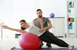 © Africa Studio - Physiotherapist working with patient in clinic