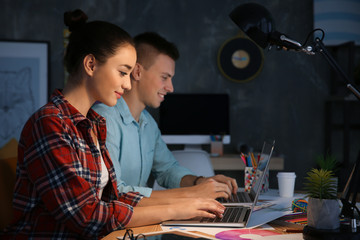 Poster - Two young designers at workplace