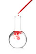 Pipette dropping a sample into a test flask on white background