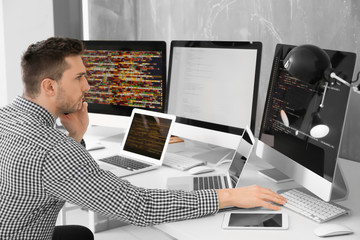 Handsome young programmer working in office