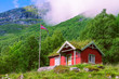 Norwegian flag and typical house in valley Innerdalen