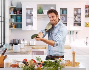 Wall Mural - Playful man having fun in kitchen