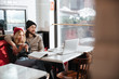 © Drobot Dean - Side view of couple hugging and sitting in cafe