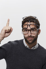 Wall Mural - Man wearing many pairs of spectacles, portrait