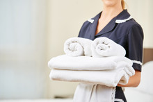 Maid With Fresh Towels During Housekeeping