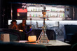 Close-up photo of transparent hookah on bar background